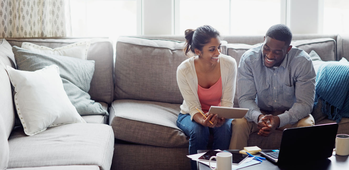 two people sitting on couch discussing something 